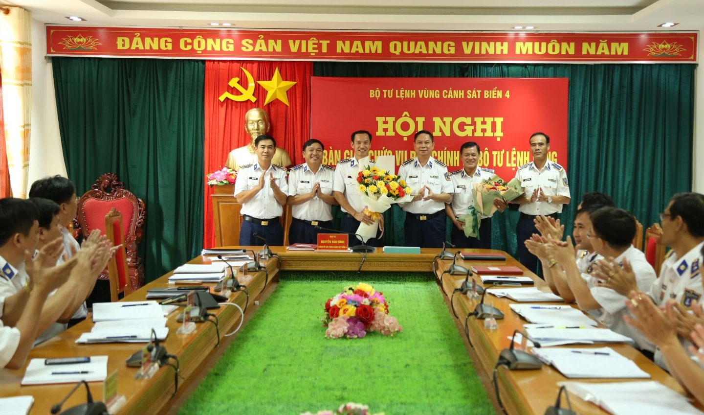 Đại tá Nguyễn Văn Dũng, Bí thư Đảng ủy, Chính ủy BTL Vùng Cảnh sát biển 4 tặng hoa chúc mừng 2 đồng chí tại Hội nghị bàn giao.